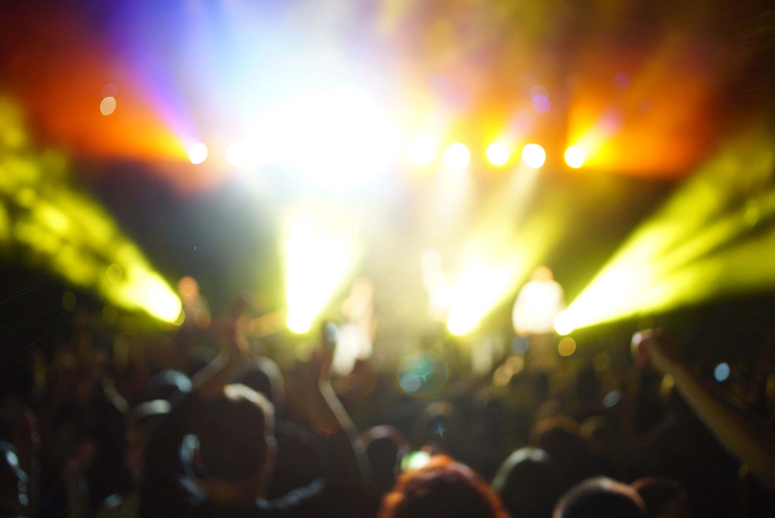 Concert-style crowd with hands in the air